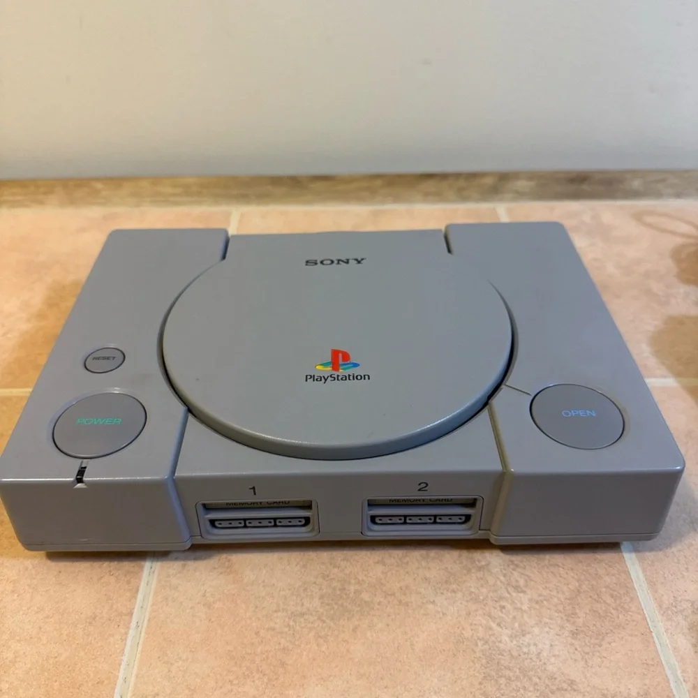 Sony Gray PlayStation Console with Two Wired Gray Controllers